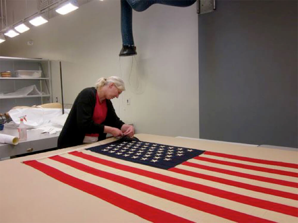Volunteer stitching American flag